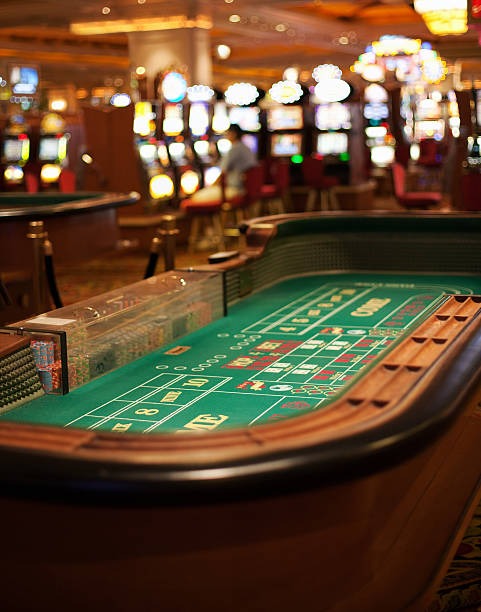 Live dealer at blackjack table with tournament schedule visible on studio monitor